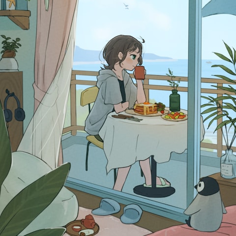 海辺の部屋のベランダで朝食を食べる女性